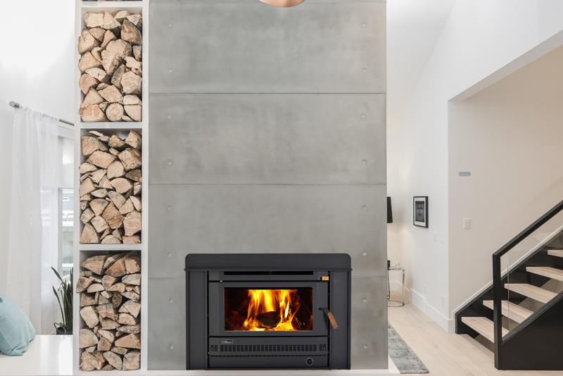 Inbuilt wood heater in a concrete feature wall